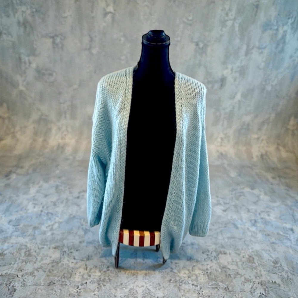 Cardigan in light blue with black writing on backside